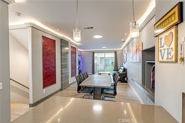dining space featuring wood finished floors and visible vents