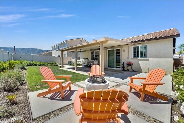 29102 Carrotwood, Lake Elsinore, CA 92530 - rear view of property with an outdoor fire pit, a patio, a fenced backyard, ceiling fan, and stucco siding