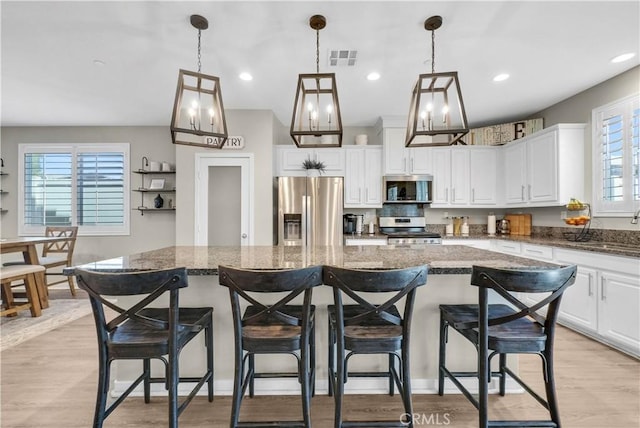29102 Carrotwood, Lake Elsinore, CA 92530 - kitchen featuring stainless steel appliances, a kitchen island, healthy amount of natural light, white cabinets, and recessed lighting