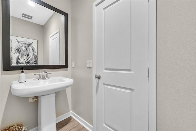29102 Carrotwood, Lake Elsinore, CA 92530 - bathroom with baseboards and wood finished floors