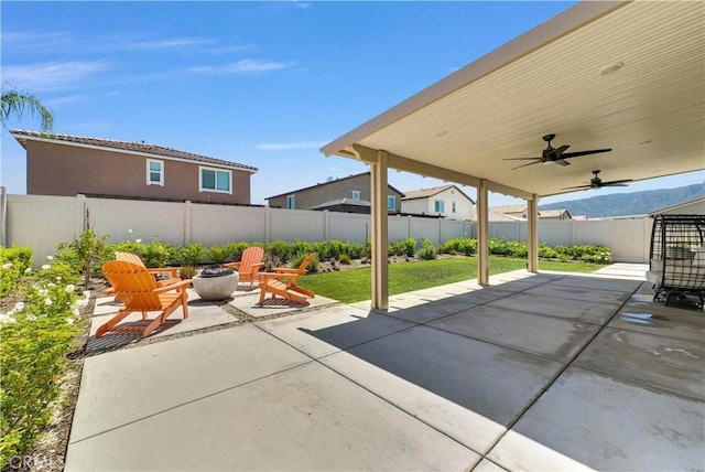 29102 Carrotwood, Lake Elsinore, CA 92530 - fenced backyard with an outdoor fire pit, a patio, and a ceiling fan