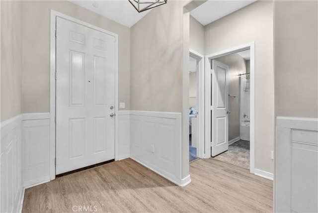 29102 Carrotwood, Lake Elsinore, CA 92530 - foyer featuring light wood-style floors, wainscoting, and a decorative wall