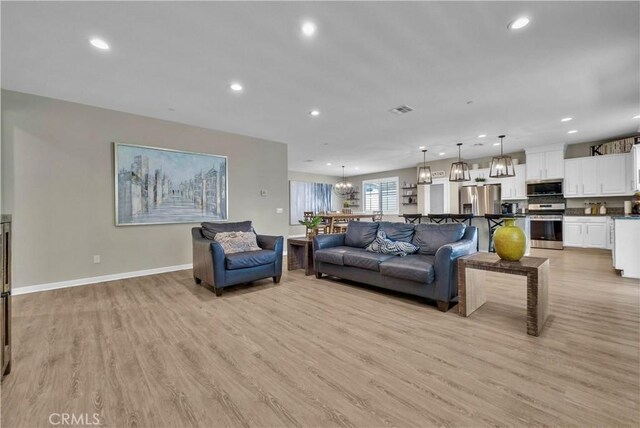 29102 Carrotwood, Lake Elsinore, CA 92530 - living area with light wood finished floors, recessed lighting, and a chandelier