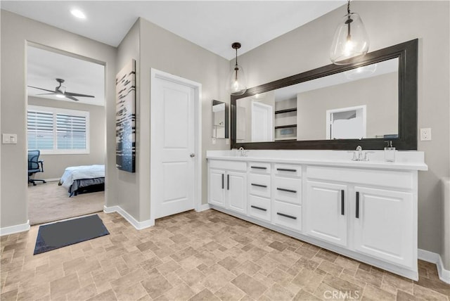 29102 Carrotwood, Lake Elsinore, CA 92530 - bathroom with double vanity, ceiling fan, stone finish floors, and ensuite bathroom