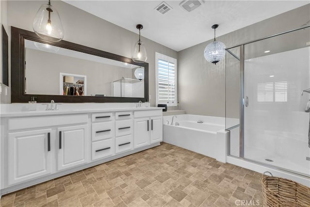 29102 Carrotwood, Lake Elsinore, CA 92530 - bathroom with stone finish floors, a shower stall, a garden tub, and double vanity