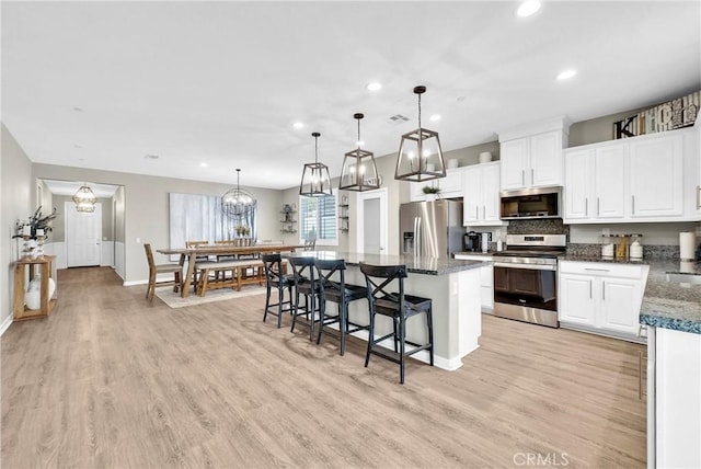 29102 Carrotwood, Lake Elsinore, CA 92530 - kitchen featuring appliances with stainless steel finishes, recessed lighting, white cabinetry, light wood-style flooring, and a kitchen island