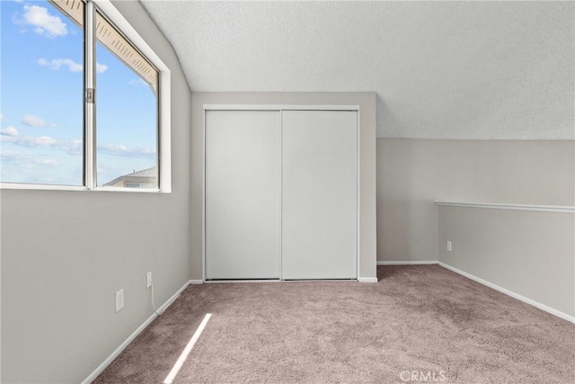 11150 Glenoaks Blvd Unit 98, Pacoima, CA 91331 - unfurnished bedroom featuring carpet, a textured ceiling, and baseboards