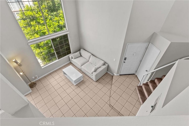 11150 Glenoaks Blvd Unit 98, Pacoima, CA 91331 - unfurnished living room with baseboards, tile patterned flooring, and stairs