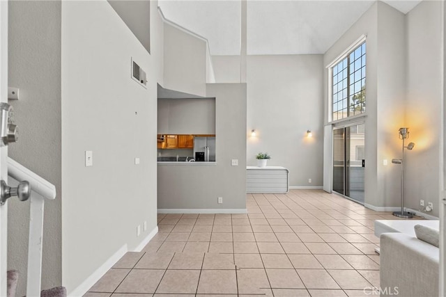 11150 Glenoaks Blvd Unit 98, Pacoima, CA 91331 - interior space featuring baseboards, a high ceiling, and light tile patterned floors