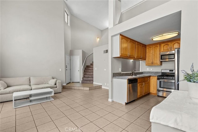 11150 Glenoaks Blvd Unit 98, Pacoima, CA 91331 - kitchen with a sink, stainless steel appliances, light tile patterned floors, high vaulted ceiling, and open floor plan