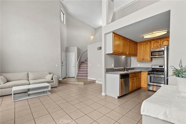 11150 Glenoaks Blvd Unit 98, Pacoima, CA 91331 - kitchen with a sink, light tile patterned flooring, high vaulted ceiling, appliances with stainless steel finishes, and open floor plan