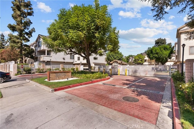 11150 Glenoaks Blvd Unit 98, Pacoima, CA 91331 - exterior space with fence, a gate, and uncovered parking