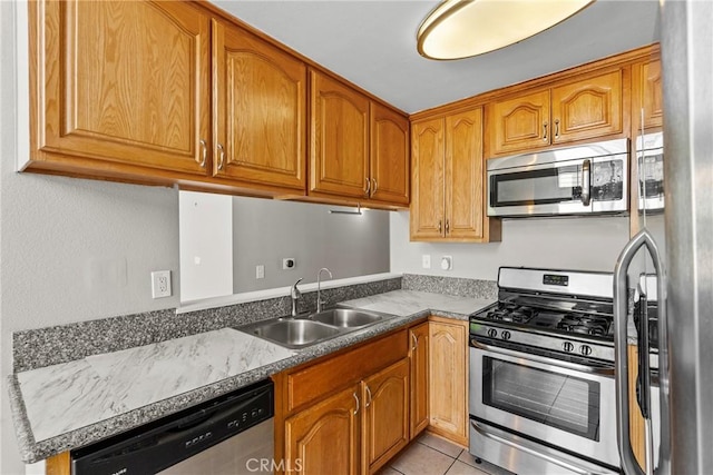 11150 Glenoaks Blvd Unit 98, Pacoima, CA 91331 - kitchen with brown cabinetry, light tile patterned flooring, a sink, and stainless steel appliances