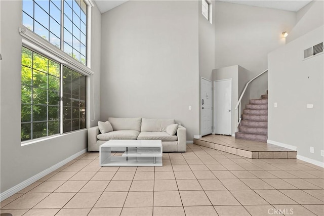11150 Glenoaks Blvd Unit 98, Pacoima, CA 91331 - living room with a high ceiling, light tile patterned floors, stairs, visible vents, and baseboards