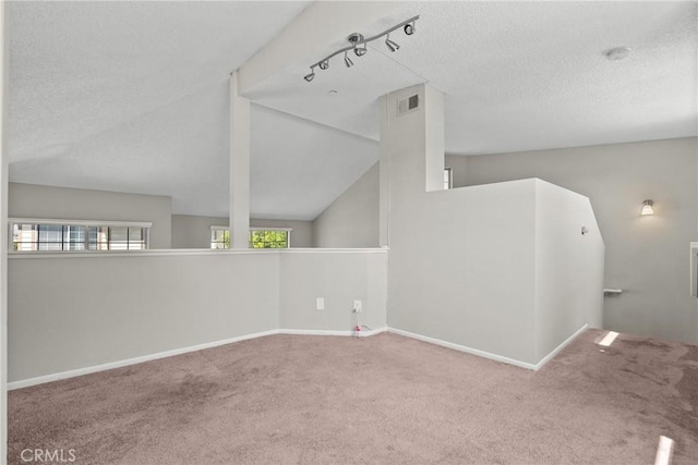 11150 Glenoaks Blvd Unit 98, Pacoima, CA 91331 - empty room with lofted ceiling, visible vents, baseboards, a textured ceiling, and carpet flooring