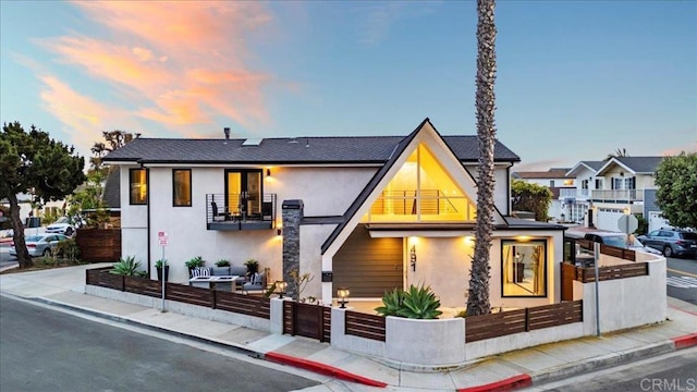 491 Prospect St, Newport Beach, CA 92663 - view of front of property with stucco siding, a balcony, and a fenced front yard