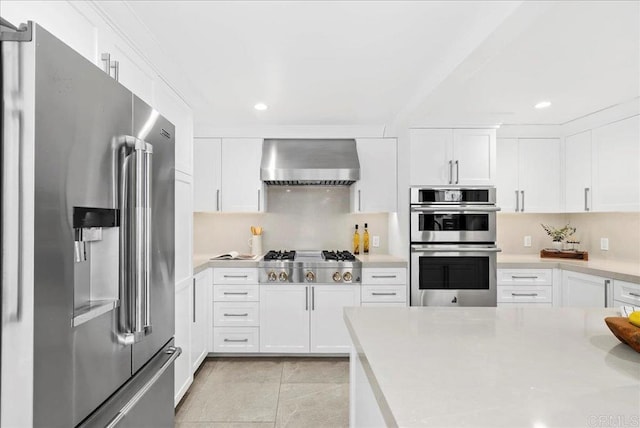 491 Prospect St, Newport Beach, CA 92663 - kitchen featuring appliances with stainless steel finishes, wall chimney range hood, light countertops, recessed lighting, and white cabinetry