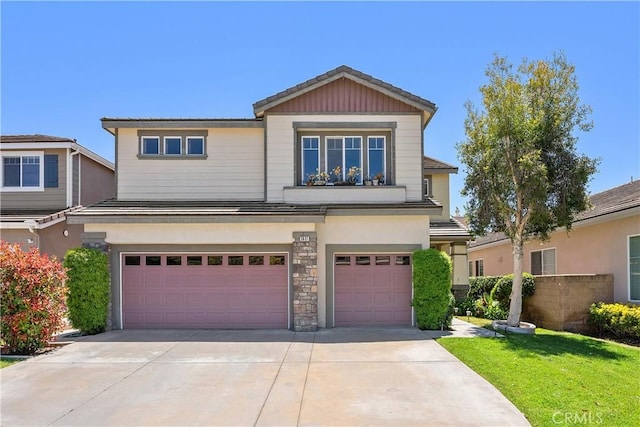 view of front of house featuring an attached garage, concrete driveway, and stucco siding