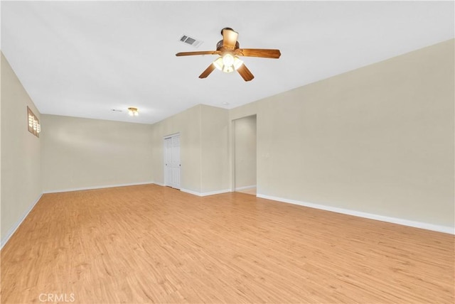unfurnished room with a ceiling fan, baseboards, visible vents, and light wood-style flooring