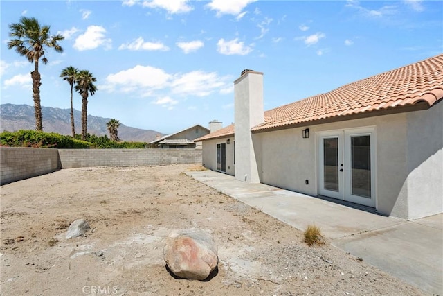 67305 Verona Rd, Cathedral City, CA 92234 - fenced backyard featuring french doors, a mountain view, and a patio