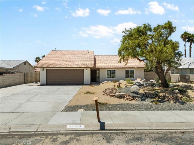 67305 Verona Rd, Cathedral City, CA 92234 - ranch-style home with stucco siding, concrete driveway, an attached garage, and a tile roof