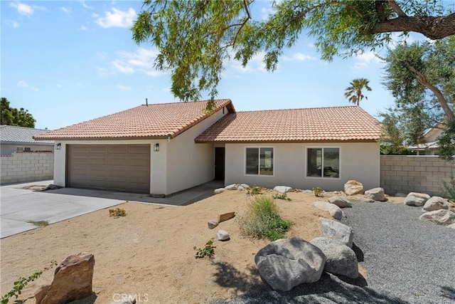 67305 Verona Rd, Cathedral City, CA 92234 - view of front of home featuring an attached garage, stucco siding, driveway, and a tile roof