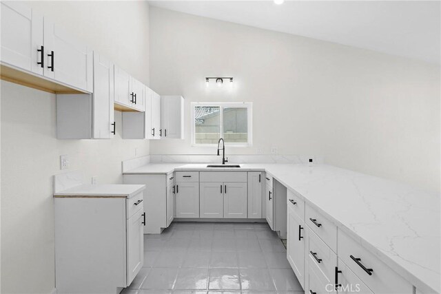 67305 Verona Rd, Cathedral City, CA 92234 - kitchen with a sink, light stone countertops, white cabinets, and light tile patterned flooring