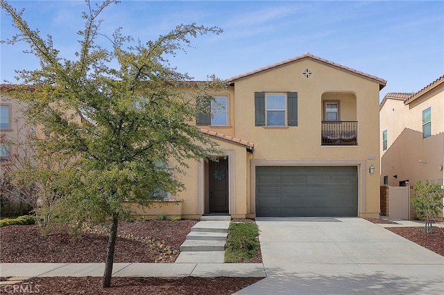 mediterranean / spanish house featuring stucco siding, a garage, driveway, and a tile roof