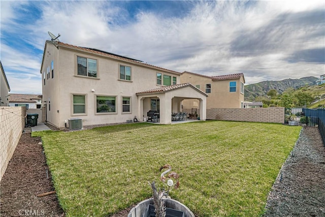 rear view of house with central AC, a patio, and stucco siding