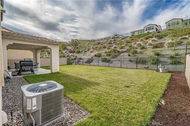 view of yard with fence, central AC, and a patio area
