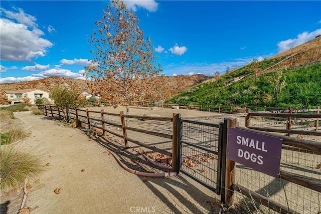 view of yard with a mountain view, a rural view, and fence