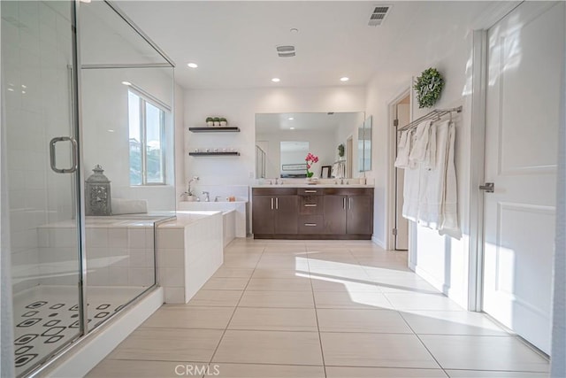 bathroom featuring tile patterned floors, visible vents, a shower stall, and a bath