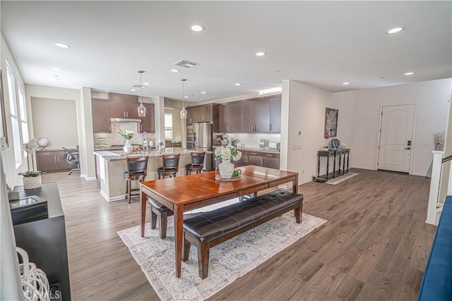 dining area with recessed lighting, wood finished floors, and baseboards