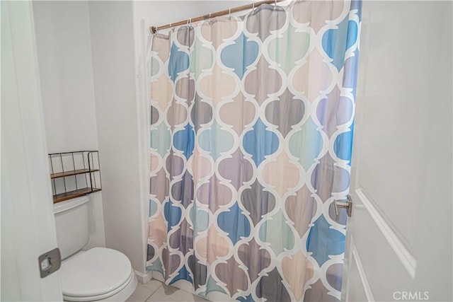 full bath featuring toilet, tile patterned floors, and a shower with shower curtain