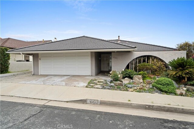 4101 Paseo De Las Tortugas, Torrance, CA 90505 - view of front facade featuring an attached garage, stucco siding, driveway, and a tile roof