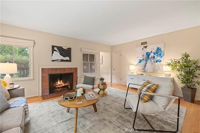 527 Bradford St, Pasadena, CA 91105 - living room with visible vents, light wood finished floors, baseboards, and a fireplace