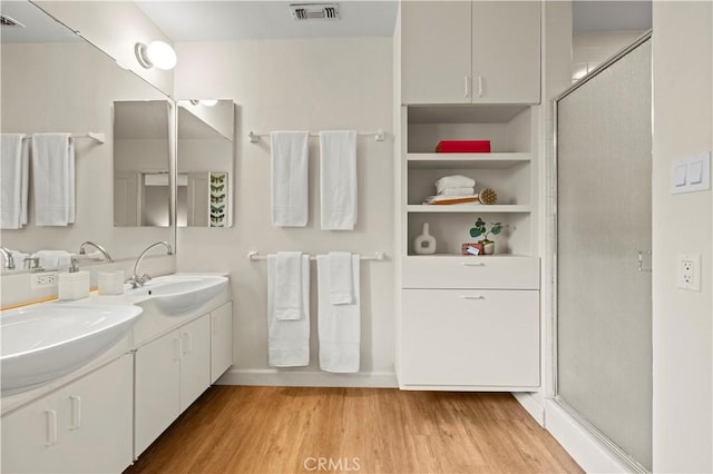 527 Bradford St, Pasadena, CA 91105 - full bath featuring a sink, a shower stall, wood finished floors, and visible vents