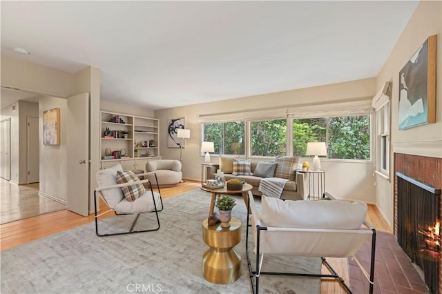 527 Bradford St, Pasadena, CA 91105 - living room with wood finished floors, a healthy amount of sunlight, and a fireplace