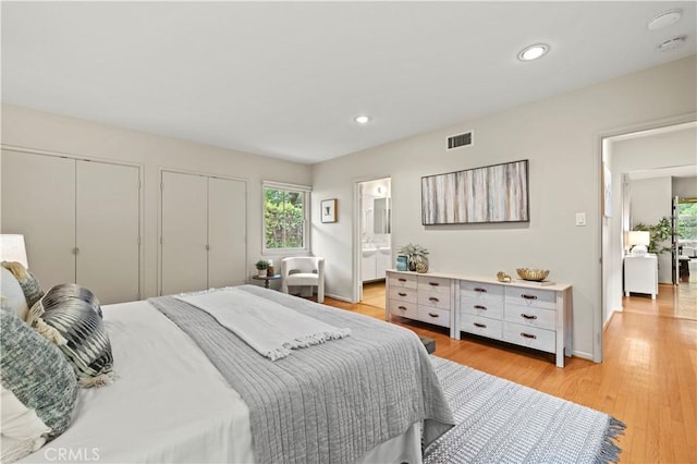 527 Bradford St, Pasadena, CA 91105 - bedroom featuring light wood finished floors, ensuite bath, two closets, recessed lighting, and visible vents