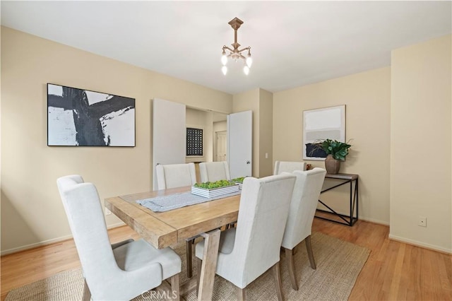 527 Bradford St, Pasadena, CA 91105 - dining area with an inviting chandelier, light wood-style floors, and baseboards