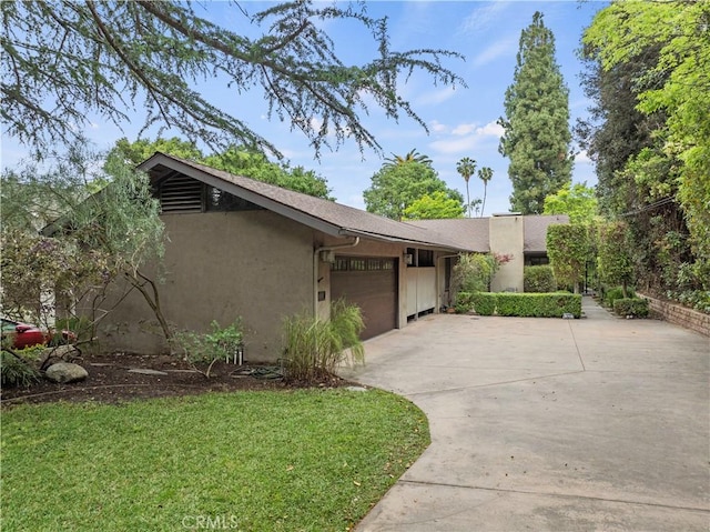 527 Bradford St, Pasadena, CA 91105 - view of front of house with a front lawn, an attached garage, concrete driveway, and stucco siding