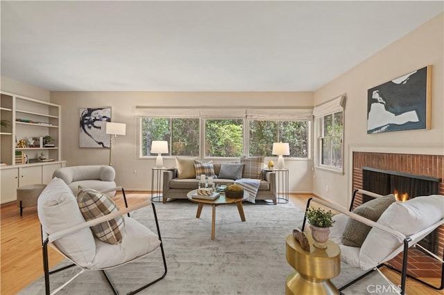 527 Bradford St, Pasadena, CA 91105 - living area featuring a brick fireplace, plenty of natural light, and wood finished floors