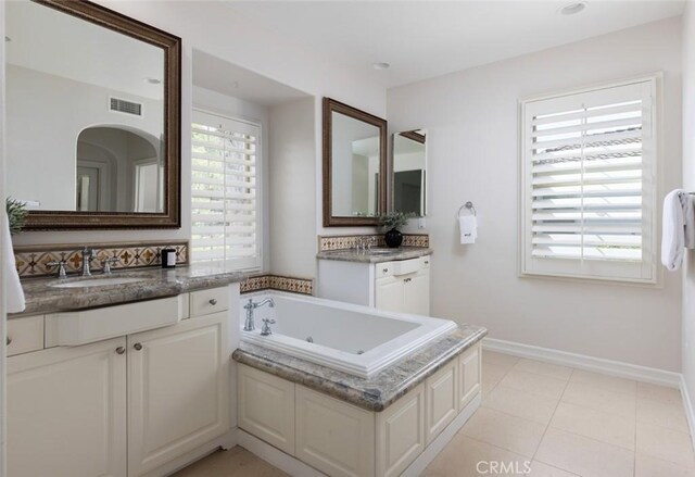 26 Via Fontibre, San Clemente, CA 92673 - bathroom with a tub with jets, two vanities, baseboards, and tile patterned flooring