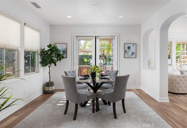 26 Via Fontibre, San Clemente, CA 92673 - dining space featuring arched walkways, plenty of natural light, wood finished floors, and recessed lighting