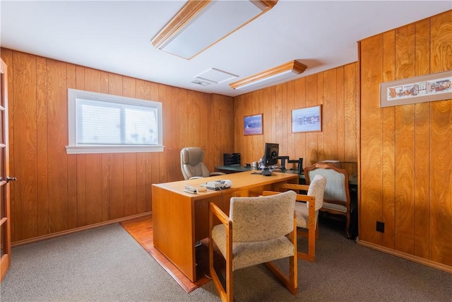 office featuring carpet and wooden walls