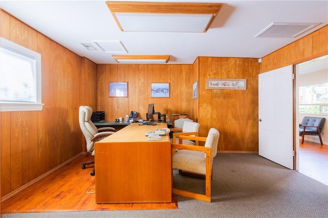 office featuring visible vents and wooden walls