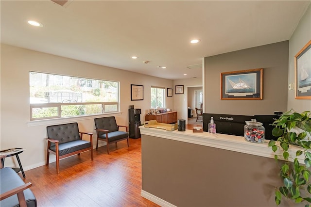 living room featuring recessed lighting, wood finished floors, and baseboards