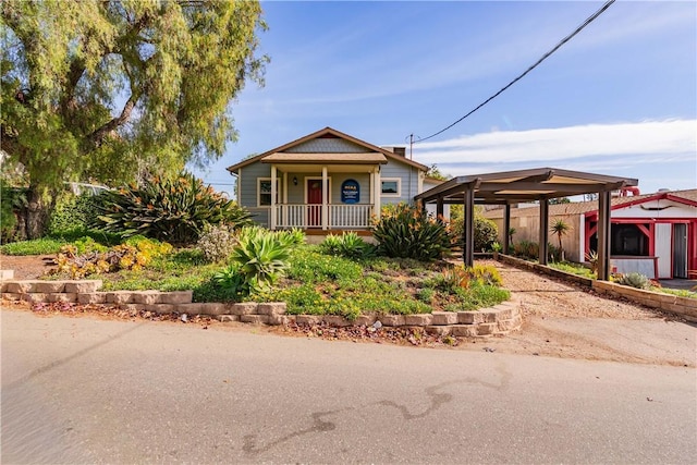 bungalow-style house with a porch and a detached carport