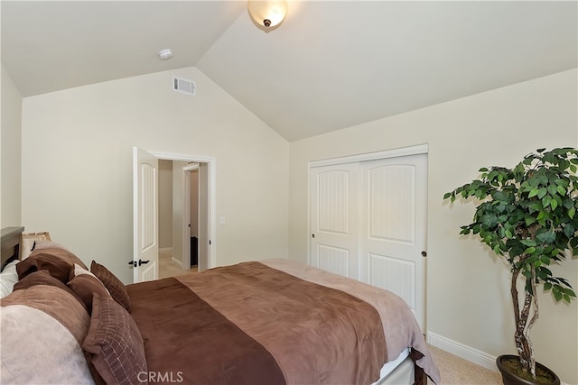 bedroom with baseboards, visible vents, a closet, and lofted ceiling
