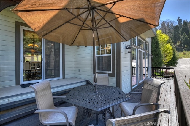 view of patio with outdoor dining space and a wooden deck